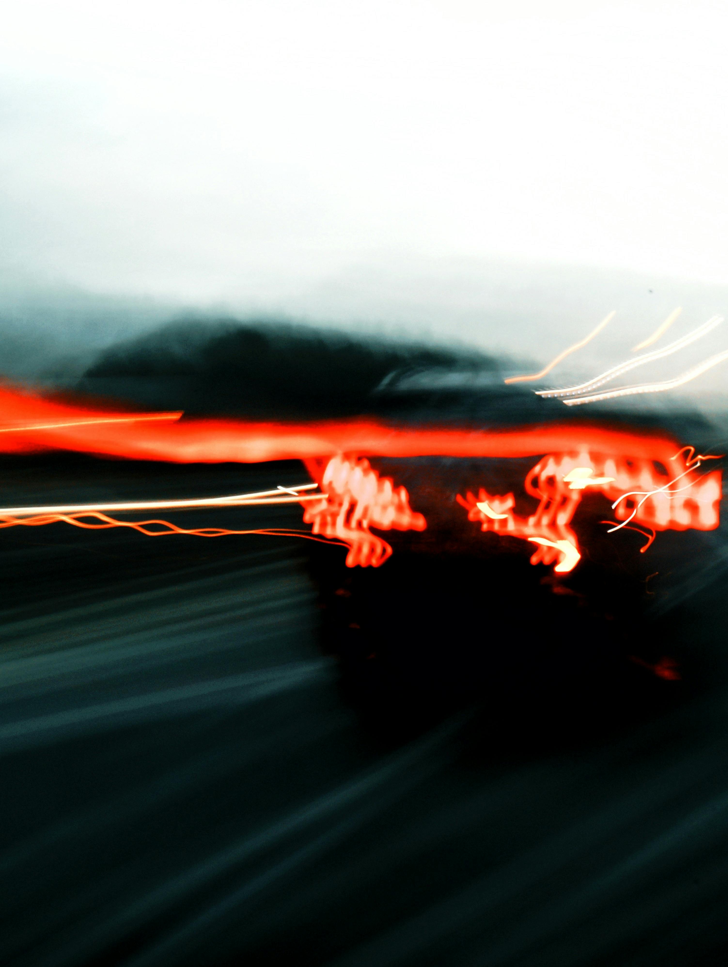 Abstract capture of colorful light trails on a highway illustrating motion and speed.