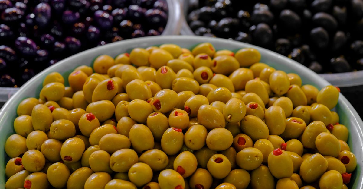 Vibrant variety of green and black olives in bowls; perfect for culinary inspiration and Mediterranean cuisine themes.