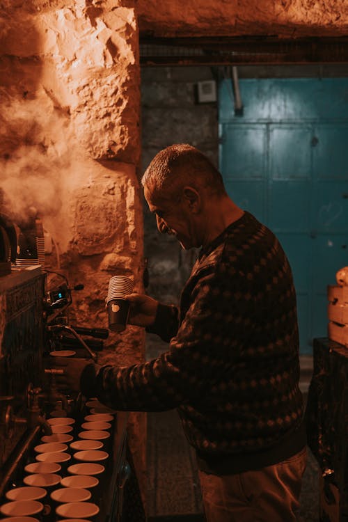 A man making coffee in a small room
