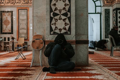 A man sitting on the floor in a mosque