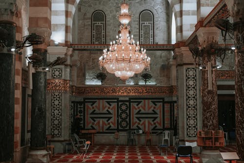 The interior of a mosque with a chandelier