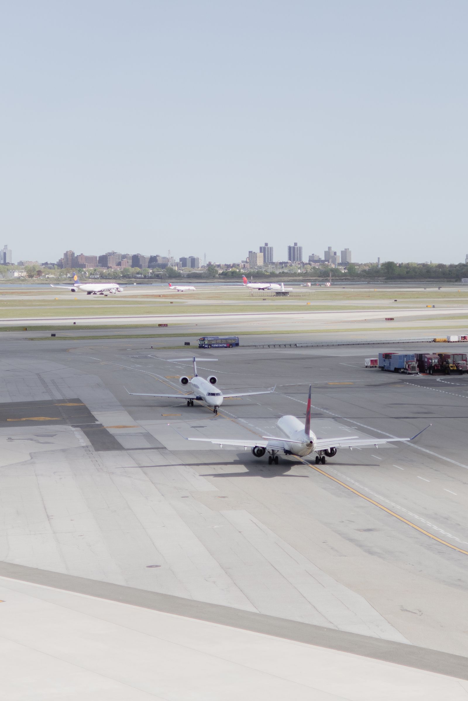 Busy airport terminal exterior with taxis and shuttle buses lined up for pickup