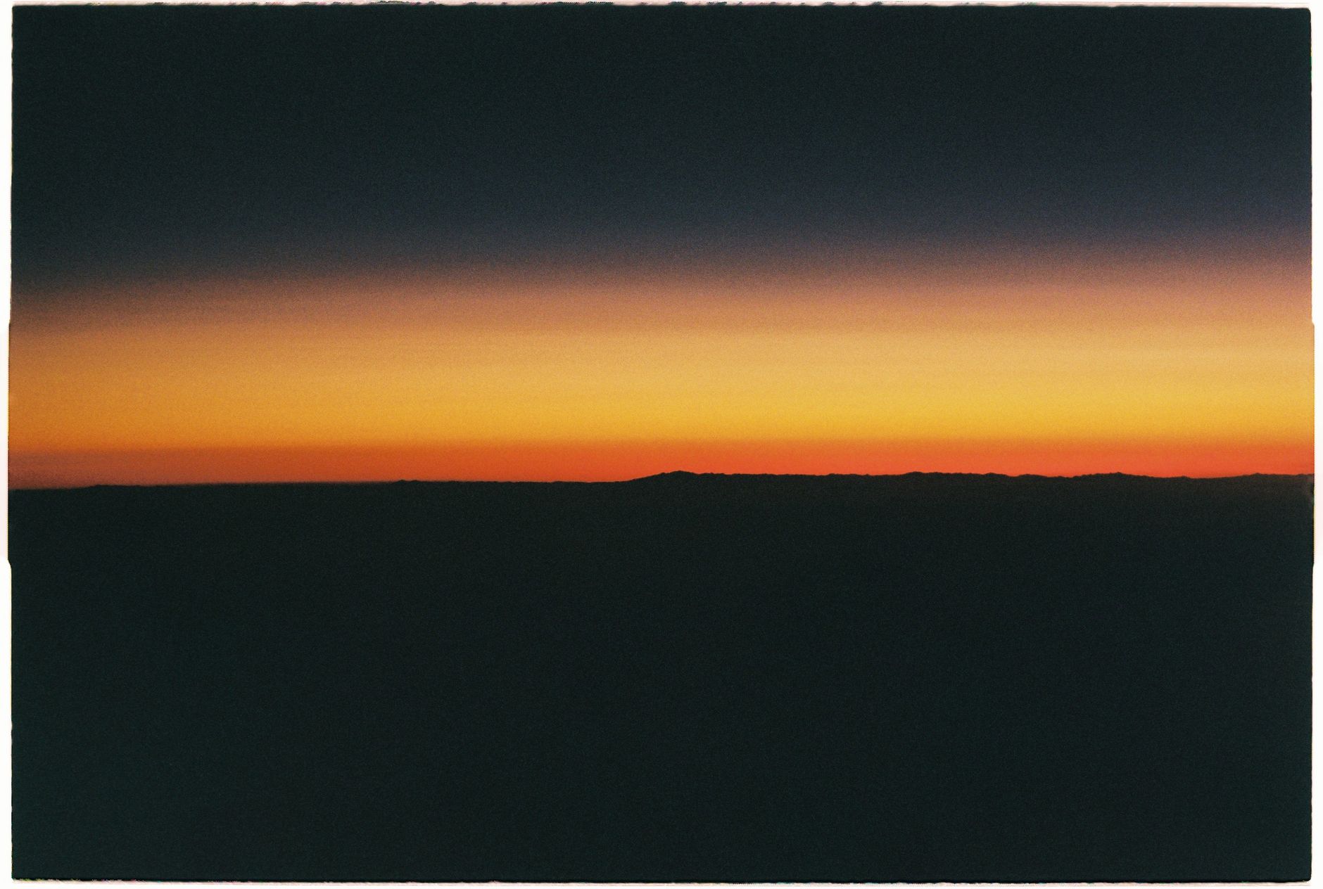 A stunning sunset silhouette with vibrant yellow sky and dark horizon.. stunning, sunset, silhouette