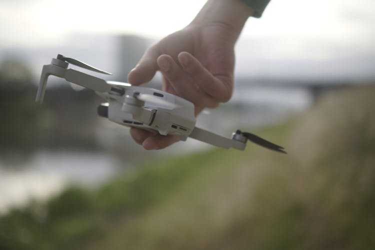 Person Holding A Quadcopter Drone In His Hand