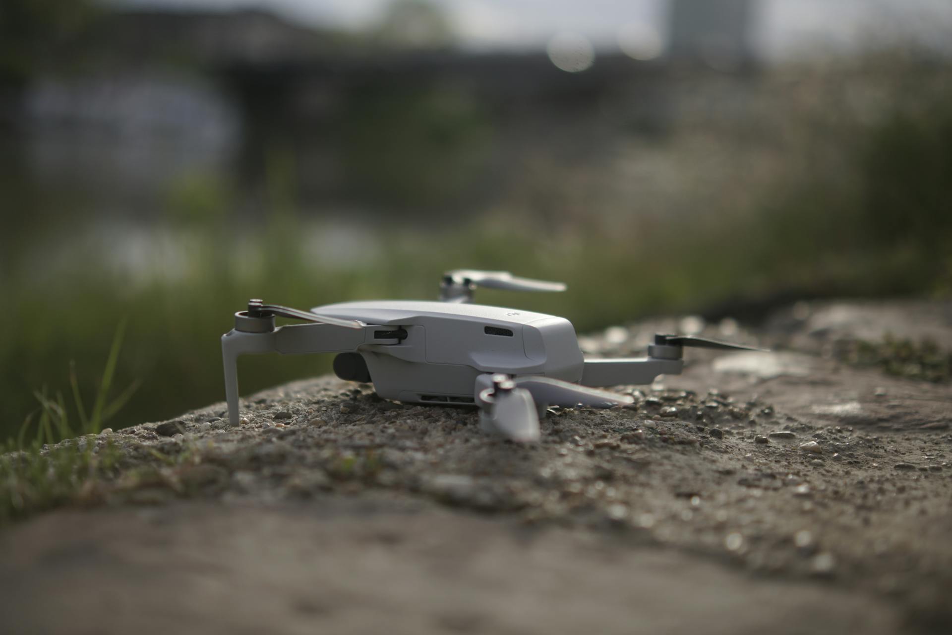 A sleek drone rests on a rocky surface outdoors in Stockholm.