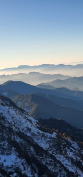 Majestic sunrise at Tungnath, India, with snow-capped mountain landscape and foggy horizons.