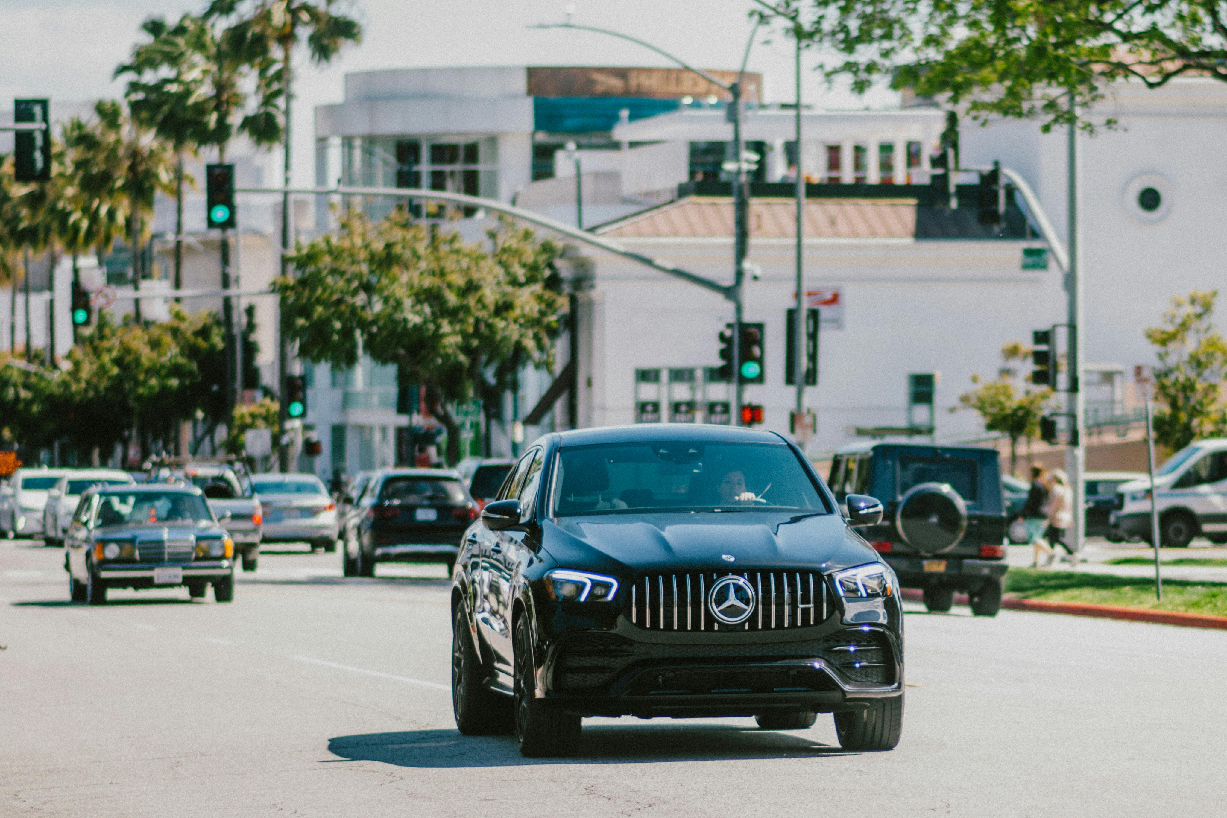 Luxury black chauffeur car driving through Los Angeles for premium executive transportation