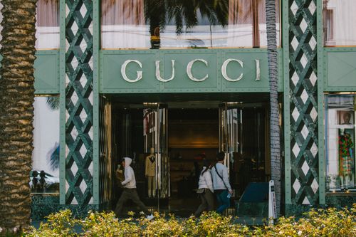 Free Gucci store facade with people passing by on a sunny day. Stock Photo