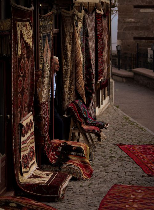 Free Beautiful traditional rugs on display outdoors, showcasing vibrant patterns and rich textures in a bazaar setting. Stock Photo