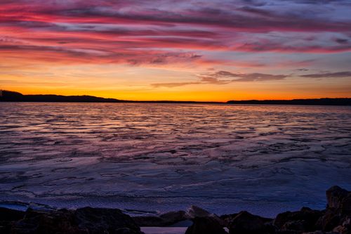Free Captivating sunset over a frozen lake in Lake City, MN, with dramatic skies. Stock Photo