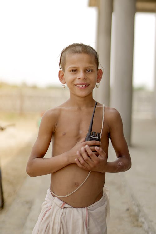 Smiling Topless Boy with Walkie Talkie