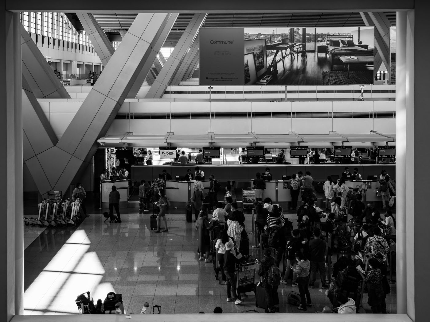 Travellers moving through a busy airport terminal