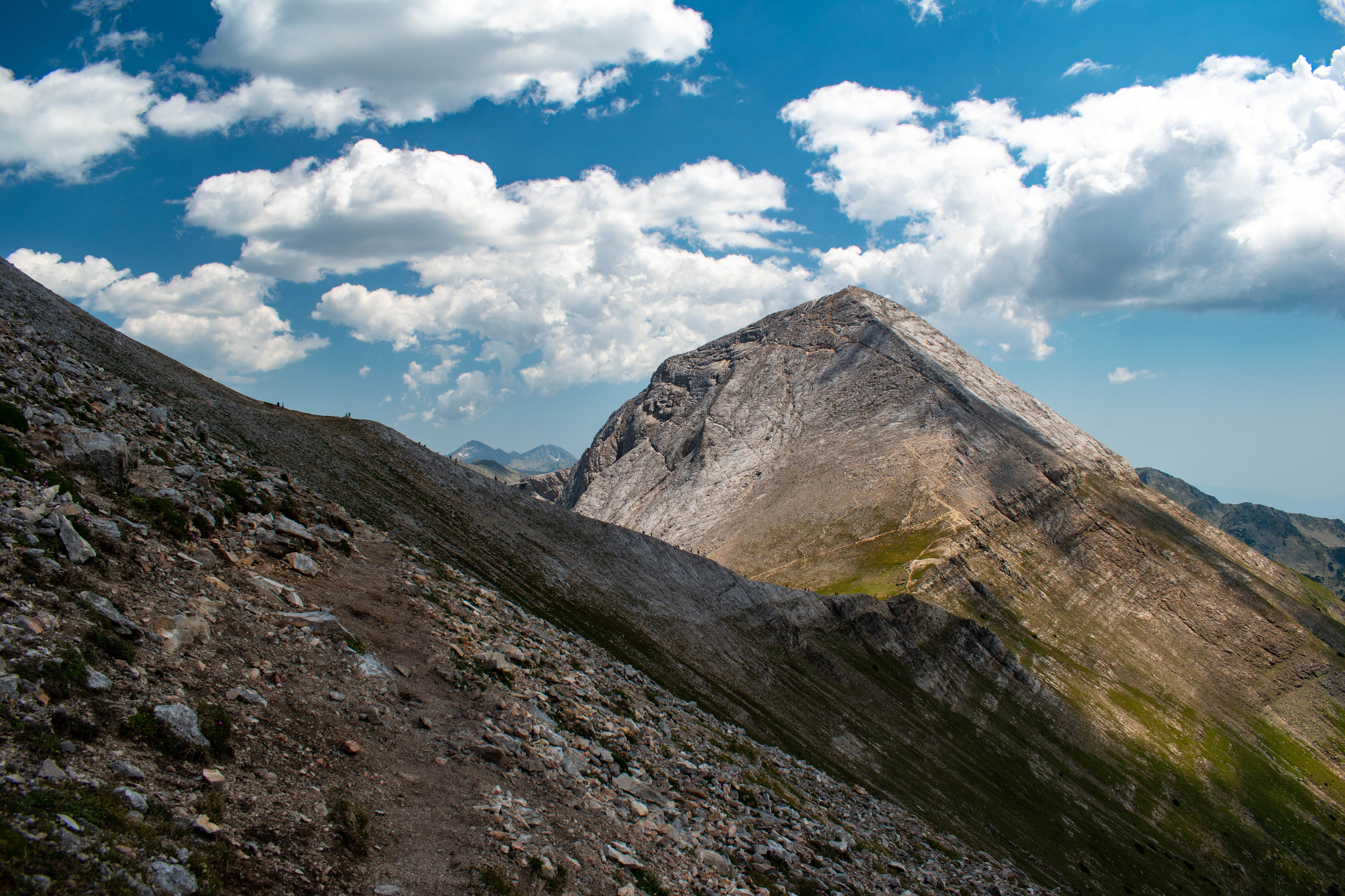 Landscape of Rocky Mountain Range under a Blue Sky with White Clouds ...