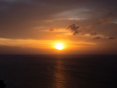 Captivating sunset over the ocean with a warm orange glow and serene horizon.