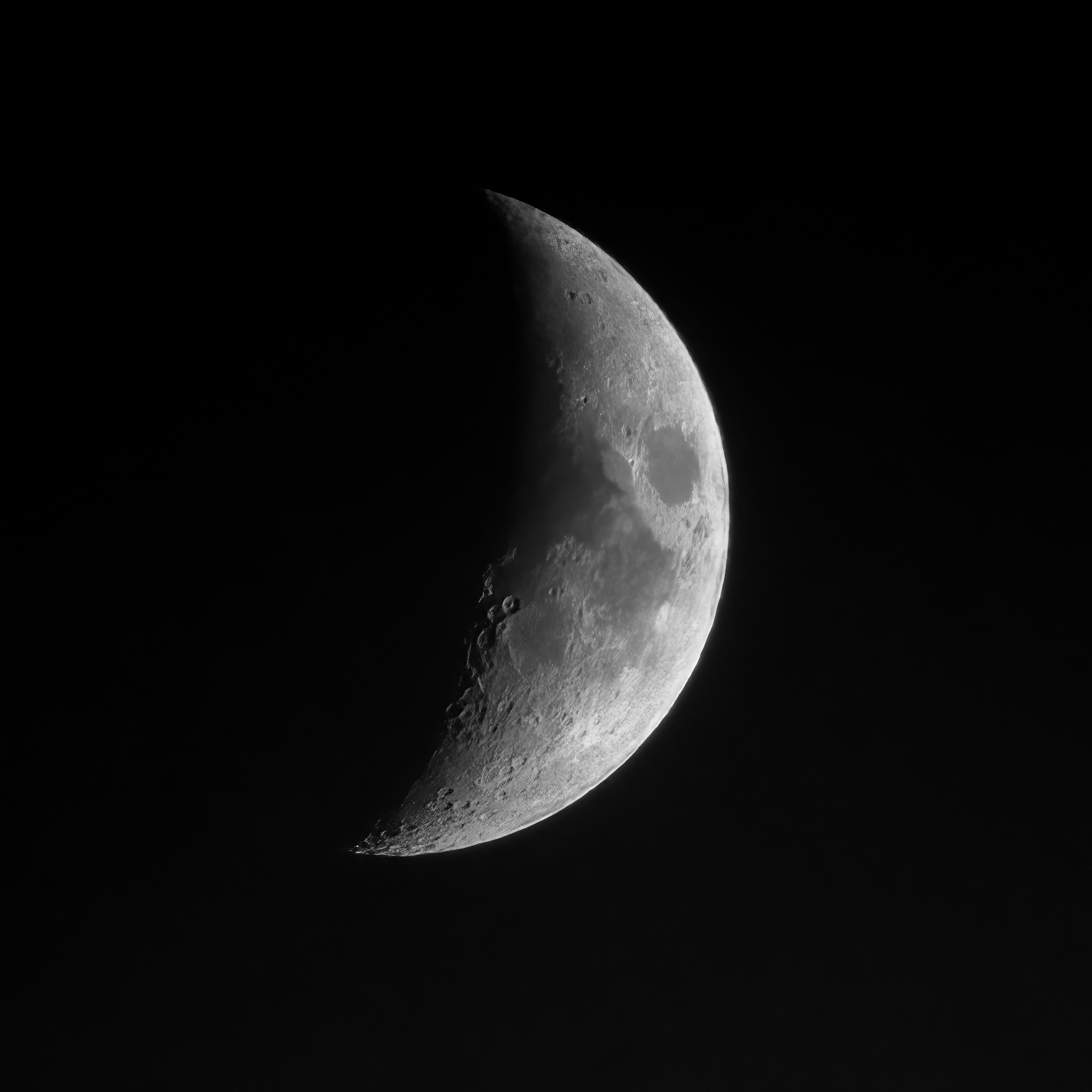 A high-resolution image of the crescent moon visible in the night sky.