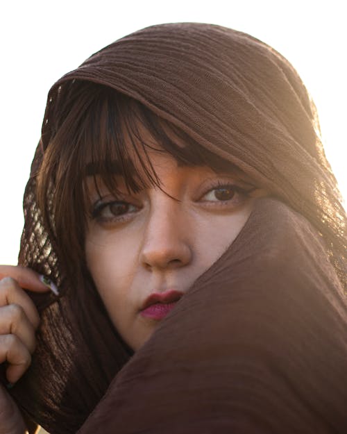 Portrait of a Young Woman Wearing a Brown Headscarf 