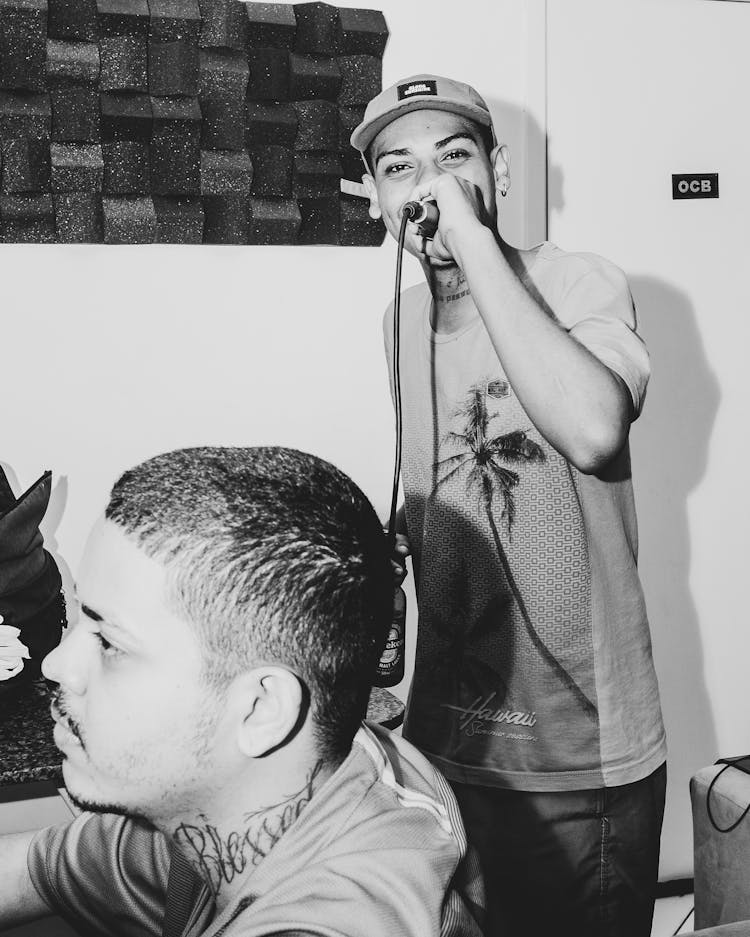 Young Man With A Microphone In A Music Studio 