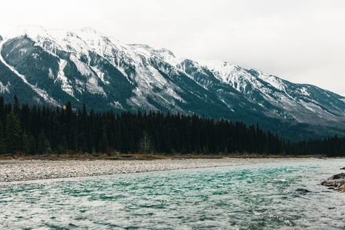 Free Stunning view of snow-capped mountains and river in Kootenay Bay, Canada. Stock Photo