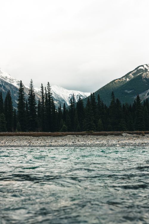 Free Beautiful lake with mountain and forest backdrop in Kootenay Bay, Canada. Stock Photo