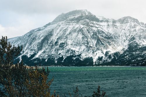 Free Snowy mountain landscape in Waterton Park, Alberta, Canada with a lake view. Stock Photo