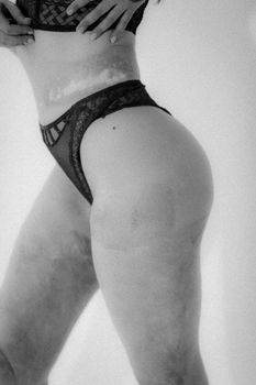Black and white close-up of a woman's body showcasing fashion art.