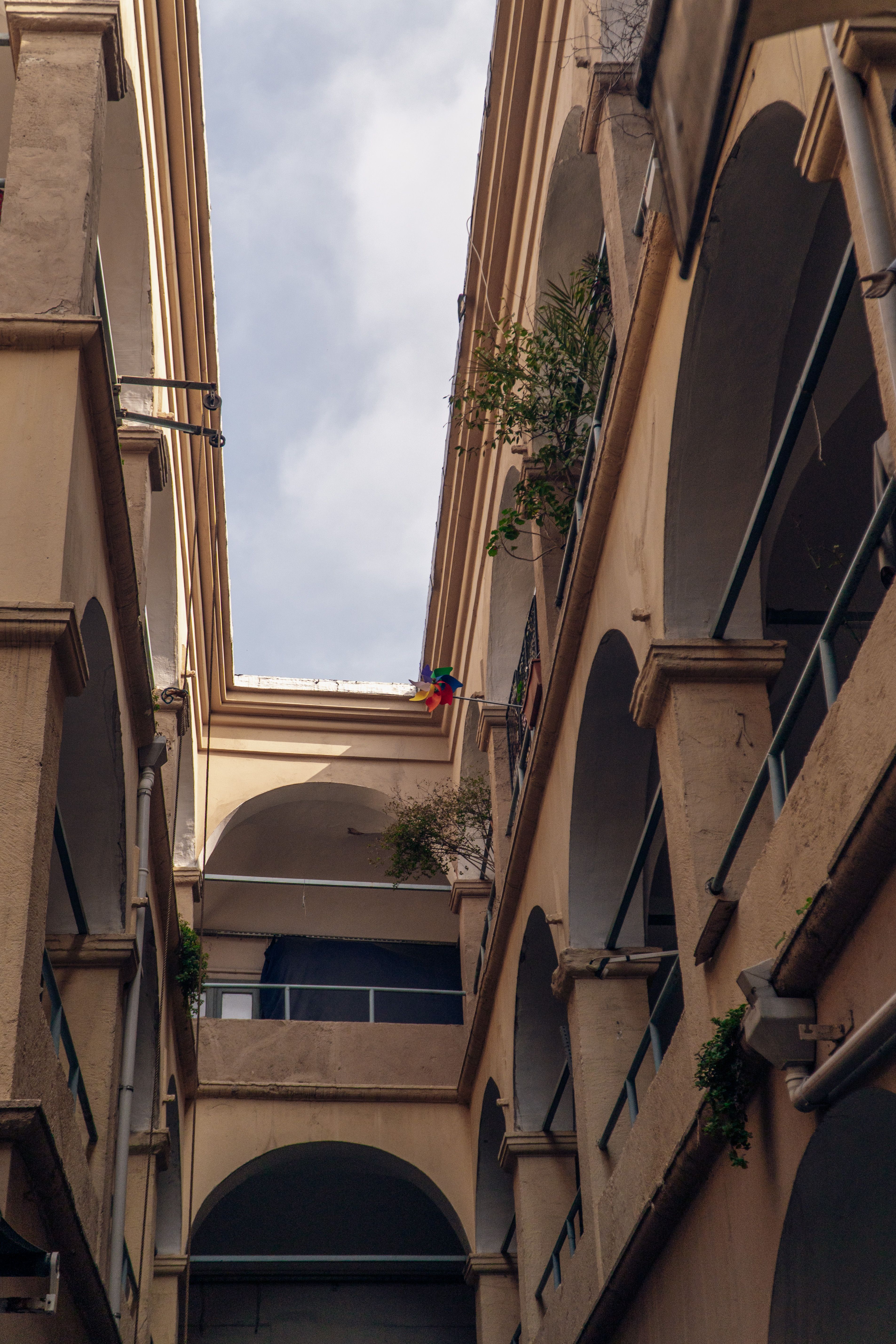 Facade of a Traditional Residential Building with Arches · Free Stock Photo