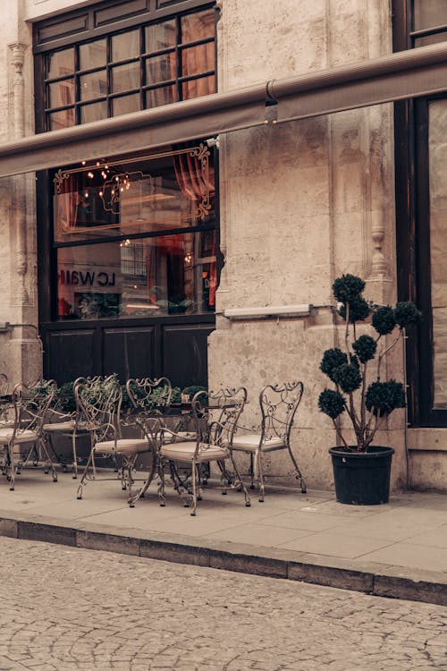Tables and Chairs Outside of an Elegant Restaurant in a Traditional Building 