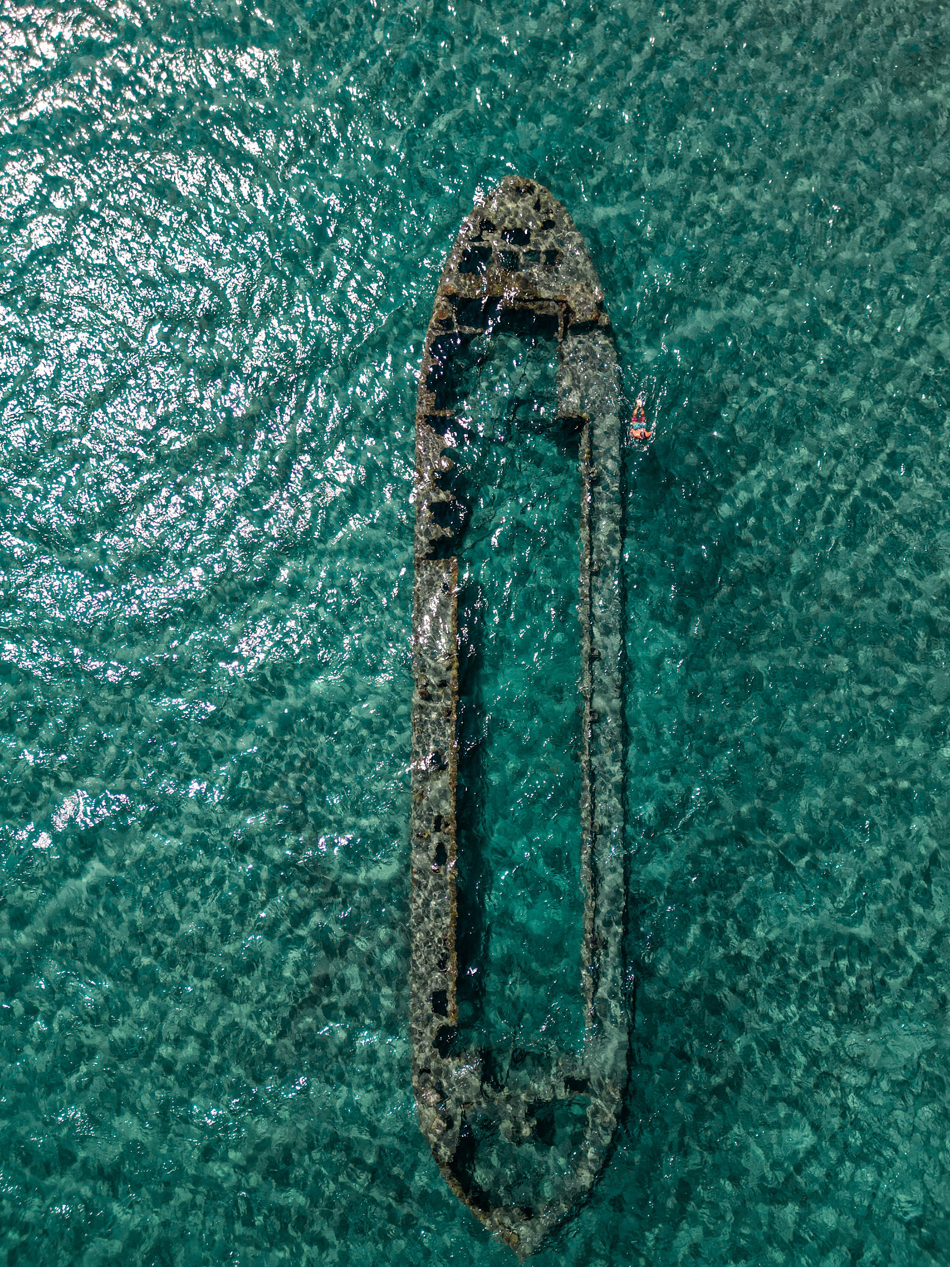 Top view of a sunken ship in clear turquoise waters near Gemikonağı, creating a stunning underwater scene.
