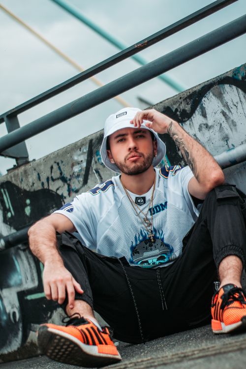 Free Young stylish man posing in Medellín, Colombia, showcasing urban fashion with a hat and tattoos. Stock Photo