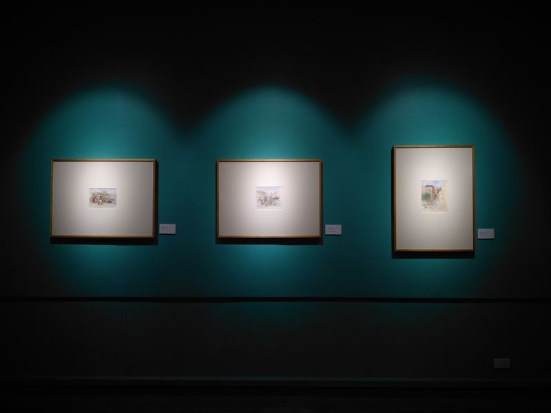 Visitors viewing paintings in a gallery