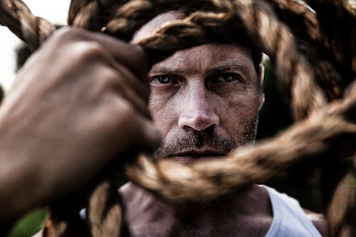 Selective Focus Photograph Of Man And Rope