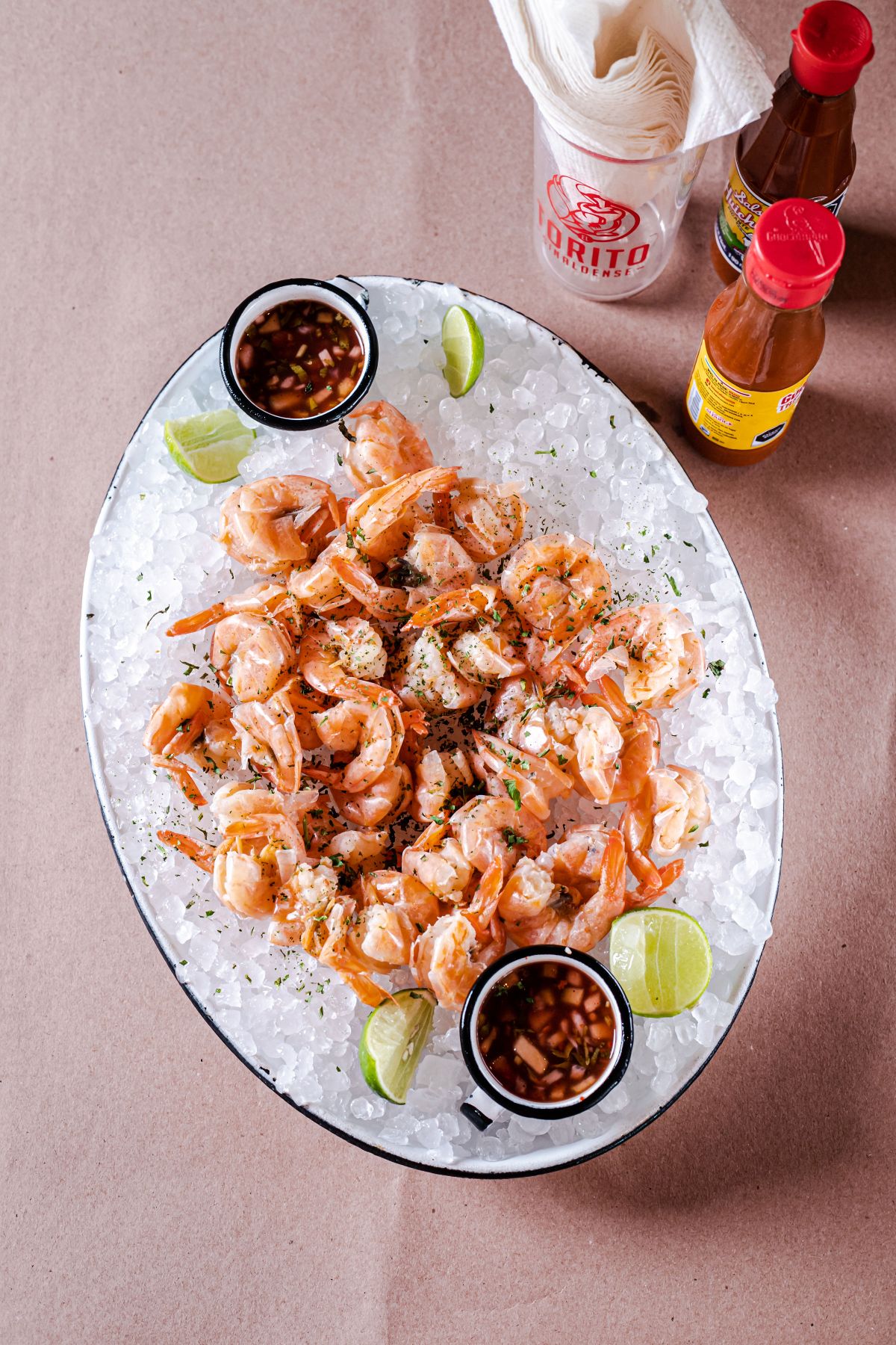 Christmas Eve dinner ideas: a seafood platter of shrimp on ice with dipping sauces