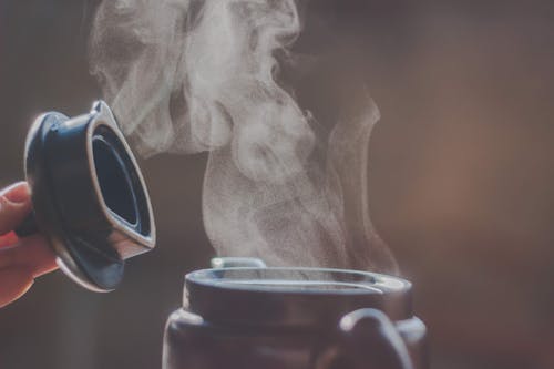 Selective Focus Photography Of Jar Releasing Smoke