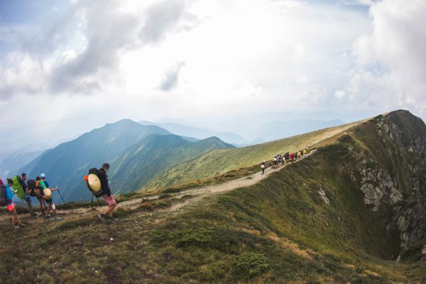 Hikers on a foggy mountain ridge, photo by Artem Mizyuk on Pexels