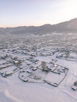 Drone capture of a serene winter village landscape in Altay Krai, Russia.