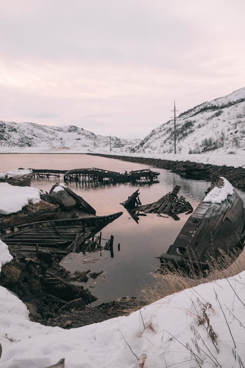 Wooden Shipwreck on Lake in Winter