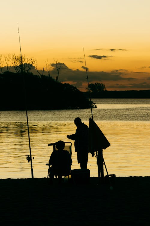 Fishing Sunset Father and Son Fishing Silhouette Stock Image