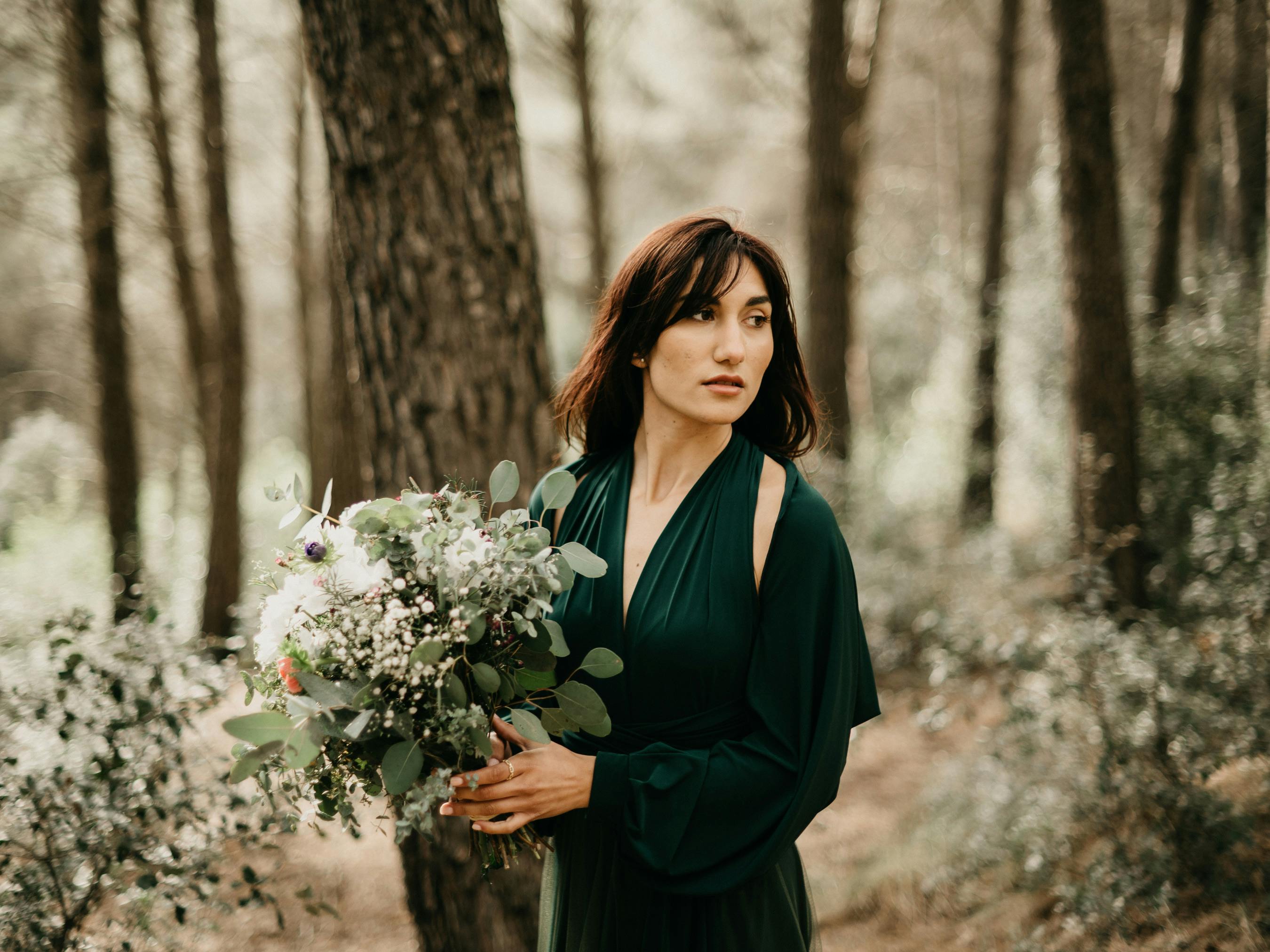 Woman Posing with Flowers in Forest