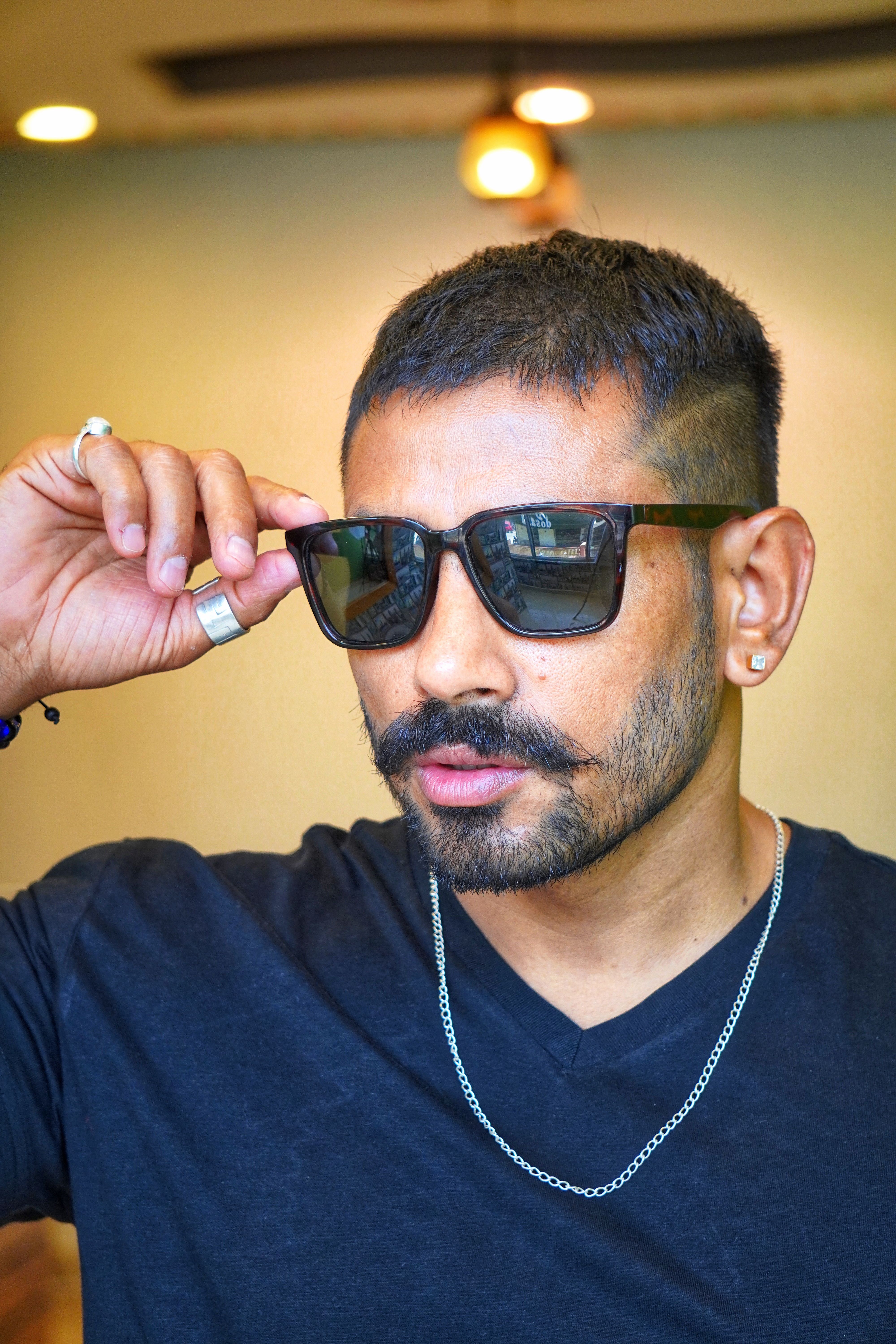 Portrait of a Man in a Blue Shirt and Sunglasses Standing Outside ...