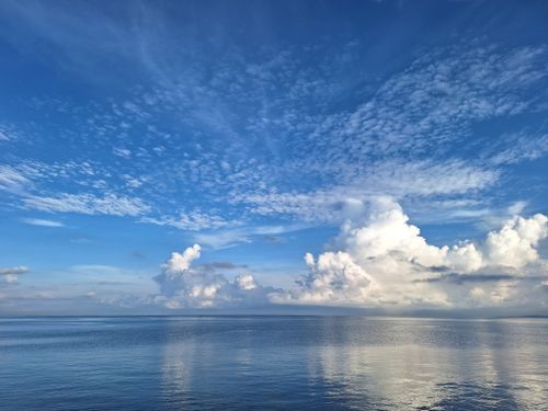 Free Stunning cloud formations over the tranquil sea in Manado, Indonesia. Stock Photo