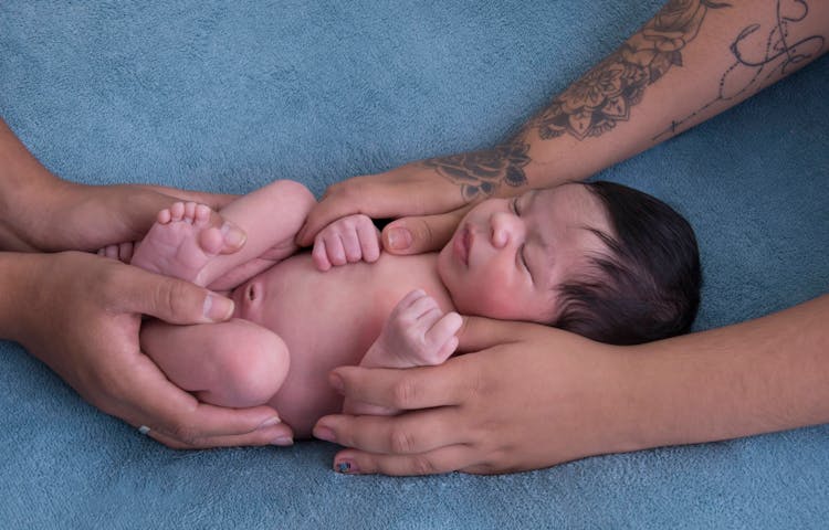 Hands Holding Sleeping Baby