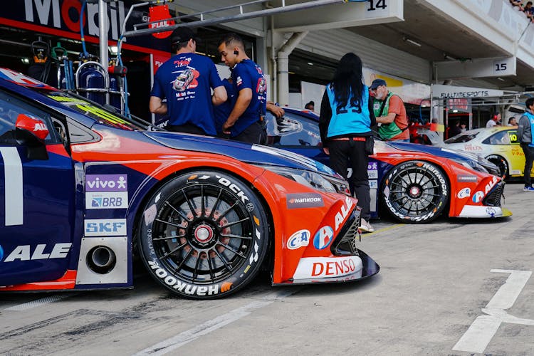 View Of Cars Parked In The Garages At A Stock Car Racing Event 