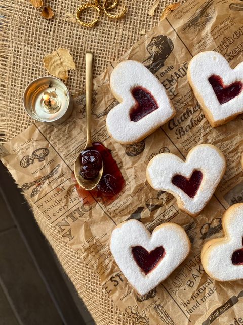 Heart-shaped jam biscuits on a rustic board, photo by Beyza on Pexels