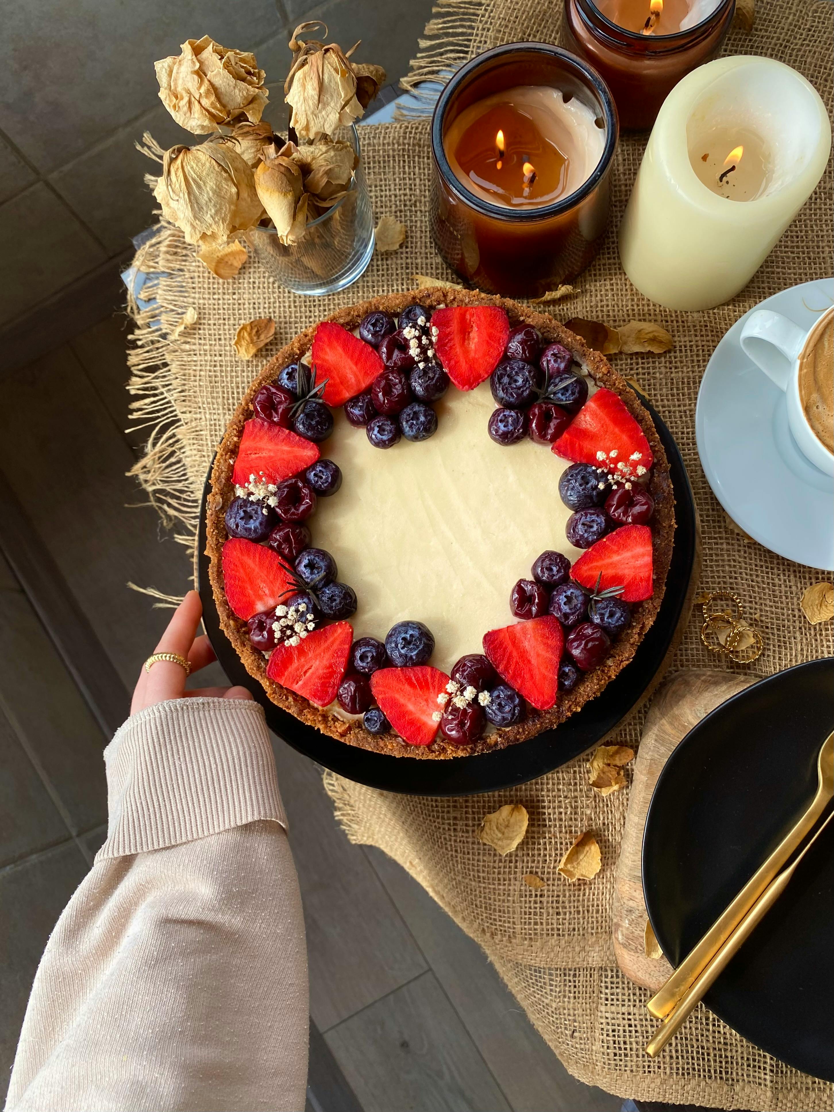 Top view of a cheesecake garnished with fresh berries, ideal for celebrations.