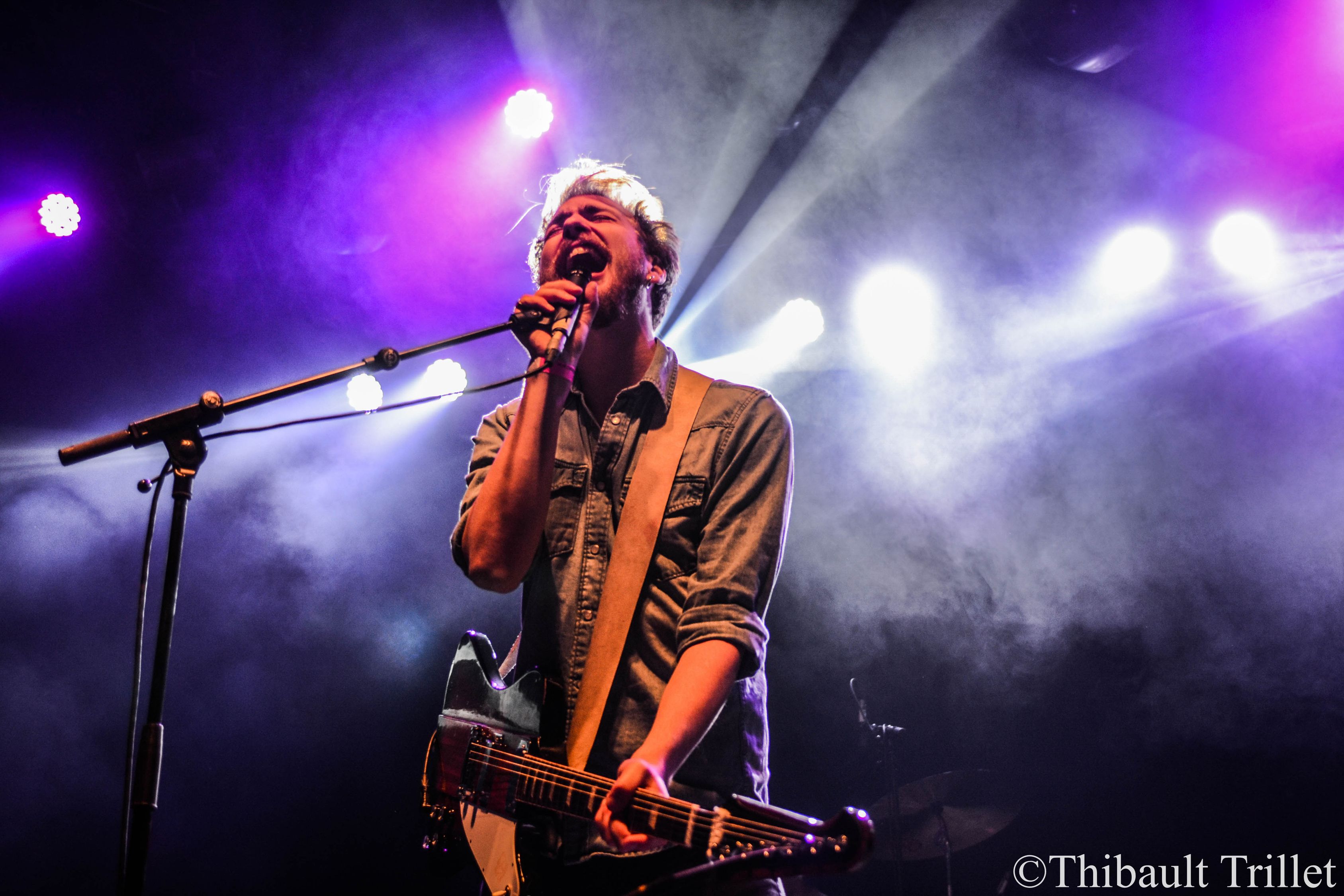 Man Singing On Stage With Strobe Lights And Guitar Free Stock Photo man-singing-on-stage-with-strobe-lights-and-guitar-free-stock-photo