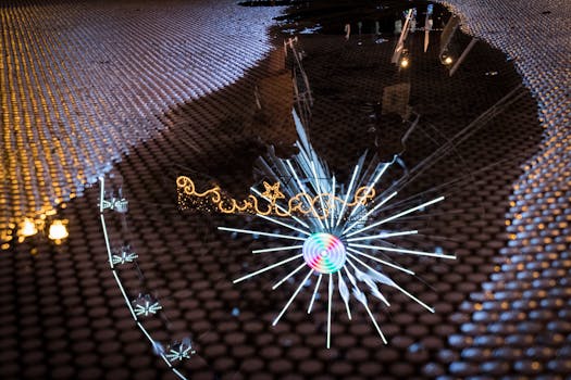 A vibrant reflection of Christmas lights and decorations captured in a wet puddle on a textured surface.