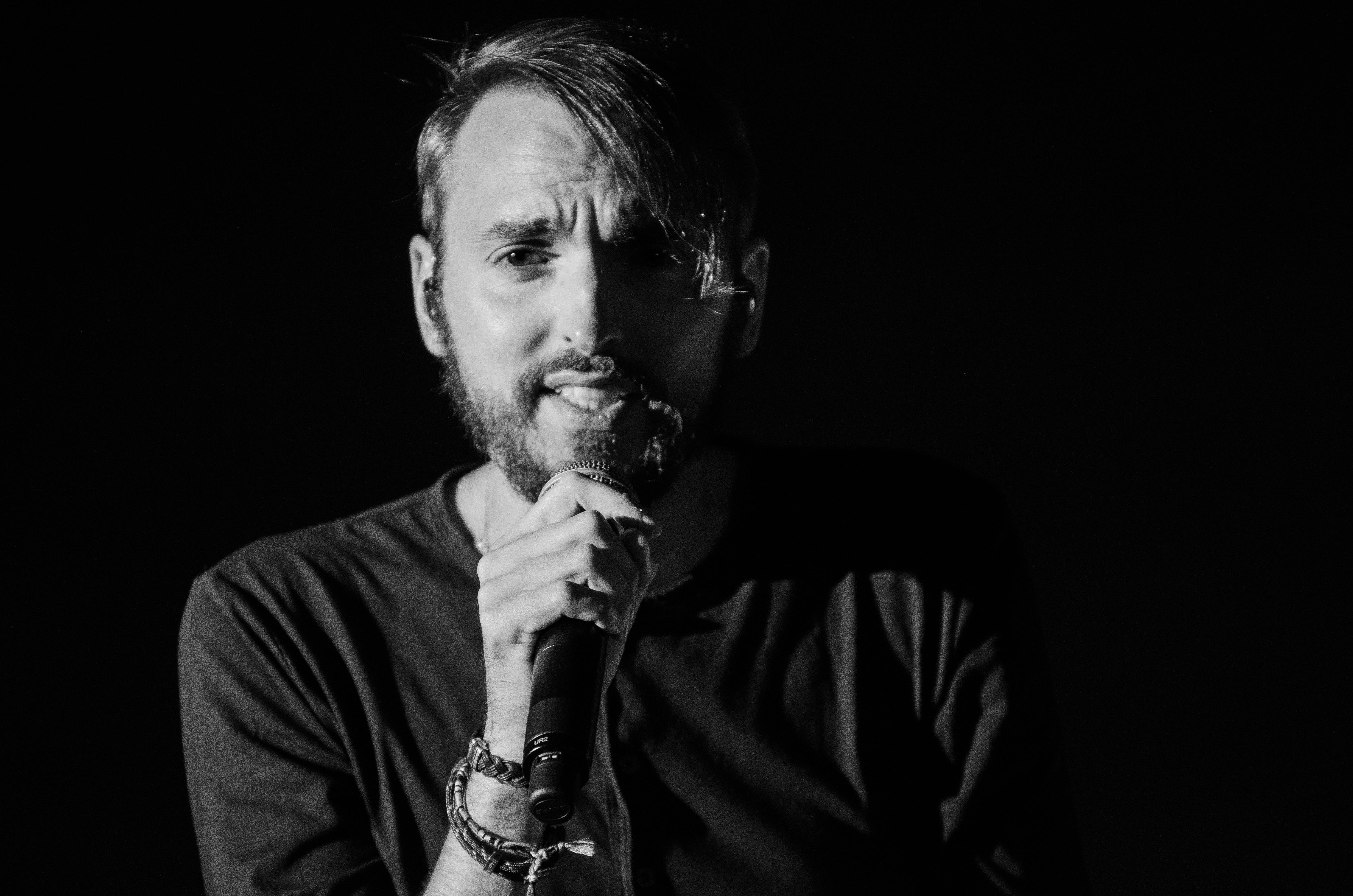 Grayscale Photo of Man Holding Microphone \u00b7 Free Stock Photo