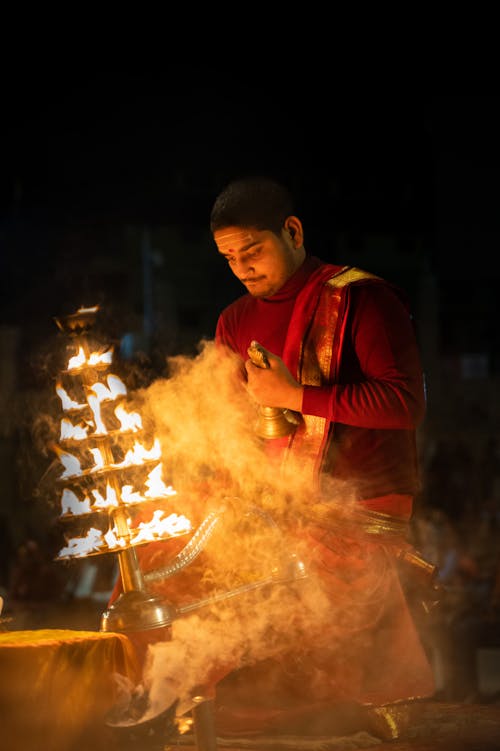 Man in Traditional Clothing at Ritual at Night