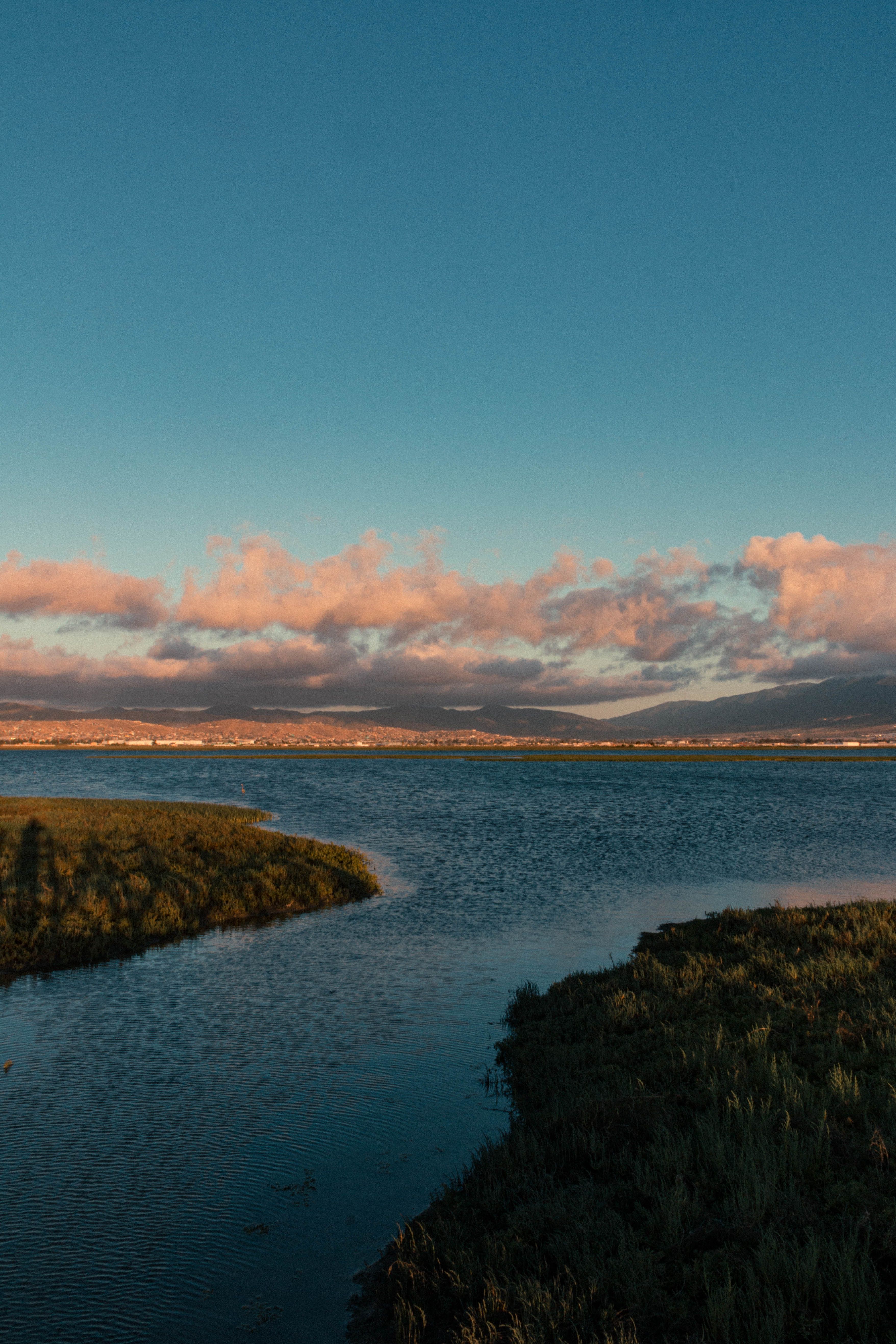 Mouth of the River into the Lake Under the Vast City · Free Stock Photo