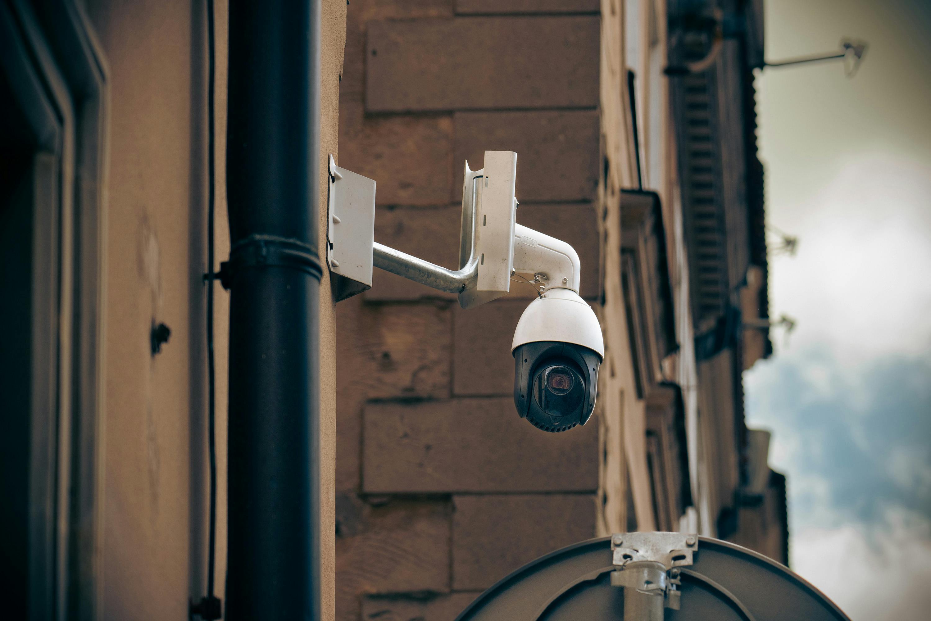 cctv camera on wall in city